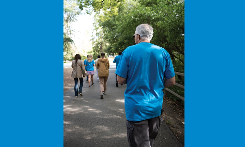 Shot of Michael walking in procession in fore ground with other participants in background