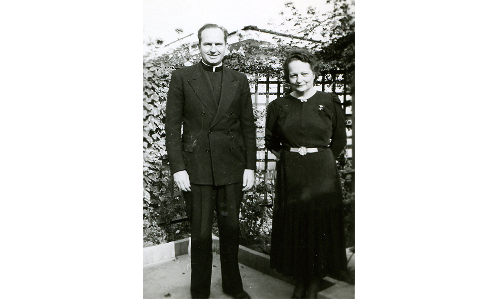 Cora and Father Frank Standing Side by Side