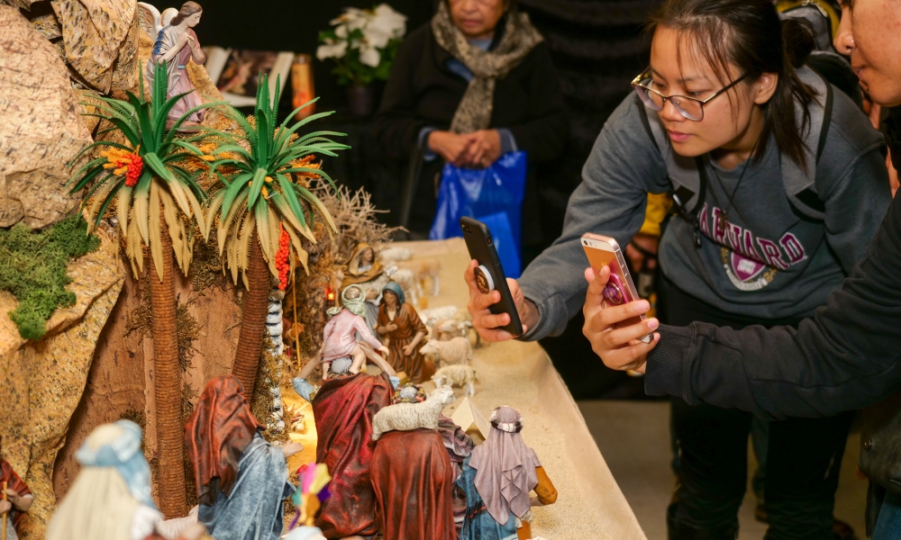 Parishioners taking pics of Nativity Diorama