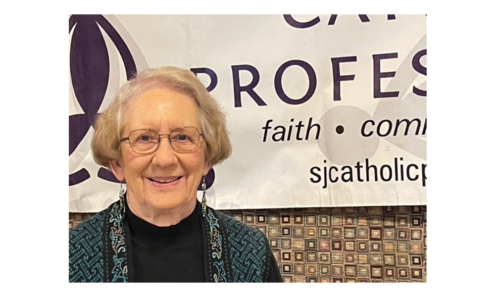 Woman gazes at camera with banner behind her