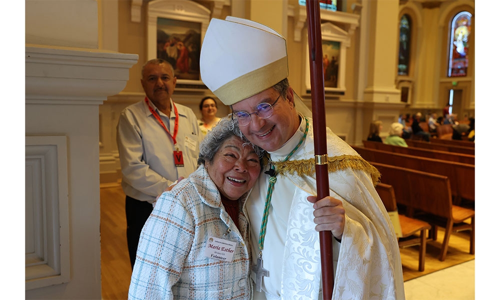 Bishop embraced by parishioner