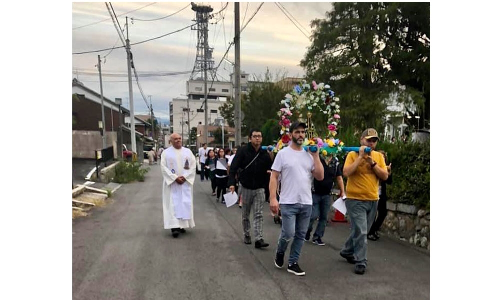 Father Roberto participates in a procession in Japan