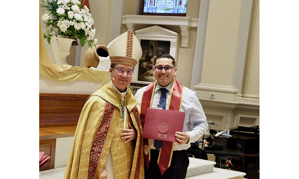 Salvador receiving diploma from Bishop Cantú