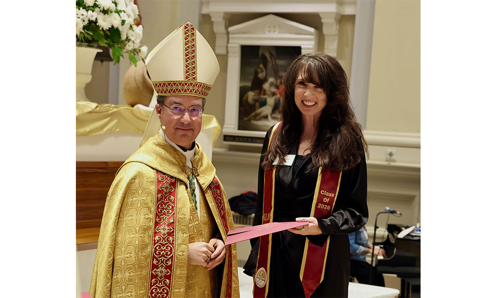 Tracey receiving diploma from Bishop Cantú