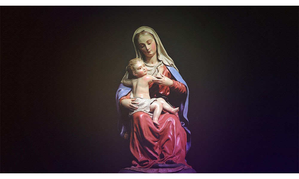 mary with toddler jesus on lap wearing purple colors